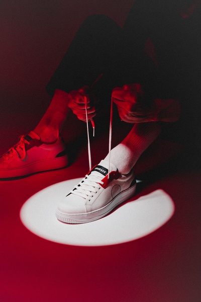 white sneakers, low top sneakers, canvas sneakers, lace up sneakers, casual shoes, brand awareness, lifestyle, editorial, bold, energetic, red, black, neutral